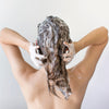 Back of a woman shampooing hair with Deep Cleansing & Clarifying Shampoo